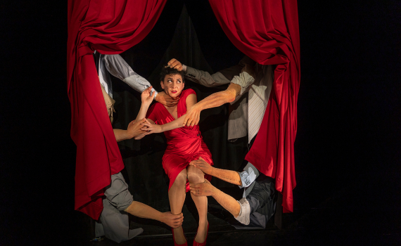 Dockskådespelare med dockor på en scen. 