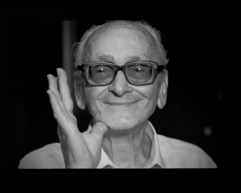 Svartvit bild på leende man i glasögon