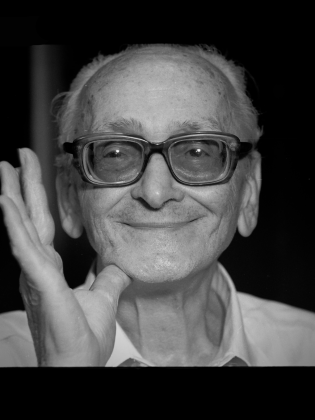 Svartvit bild på leende man i glasögon